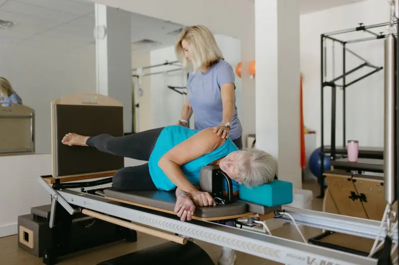 Karen Malin Garfield working with Pilates client