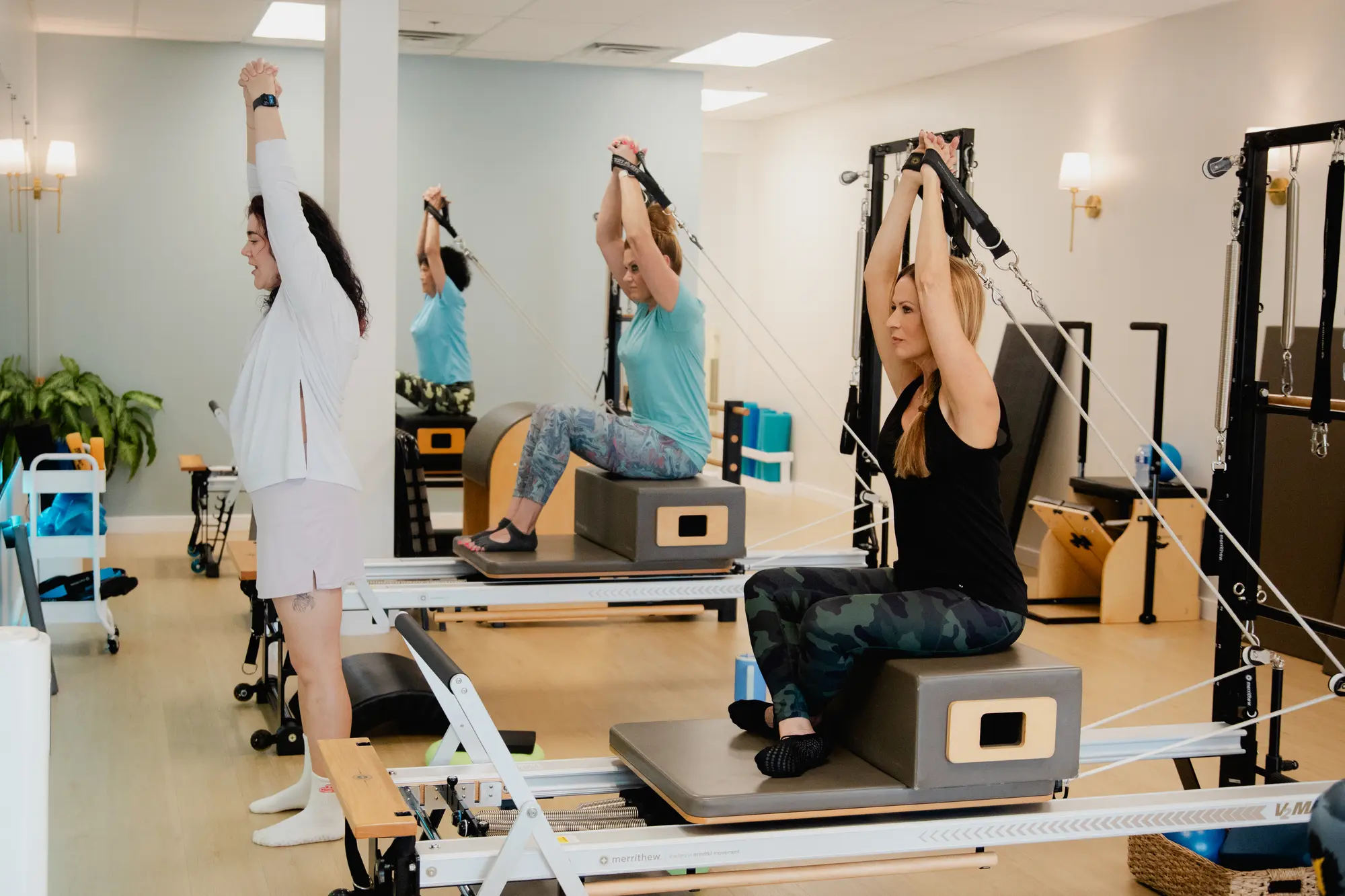 Women exercising on Pilates reformers at Pilates Franklin