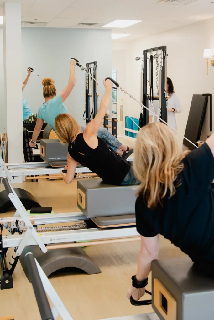 Women exercising on Pilates reformer machines in a studio in Franklin Tennessee